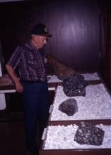 a man looking at some of the minerals on display