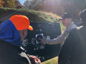 A hunter and ranger looking at a practice target