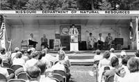 a crowd of people listen to a speaker