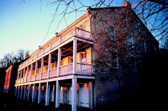 white rock Lohman Building with white railed porches