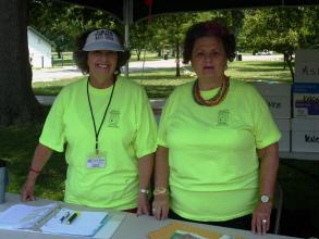 two women volunteers helping at the information booth on the Katy Trail Ride