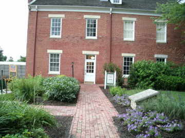 two-story, red brick Union Hotel building with garden in front