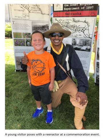A child poses with a reenactor at a commemoration event.