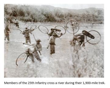 Members of the Iron Riders 25th Infantry crossing a river.