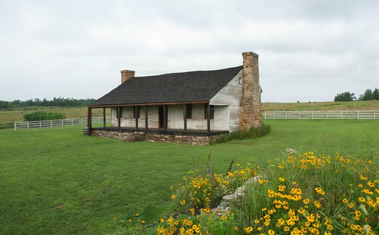 an old white and brick cabin