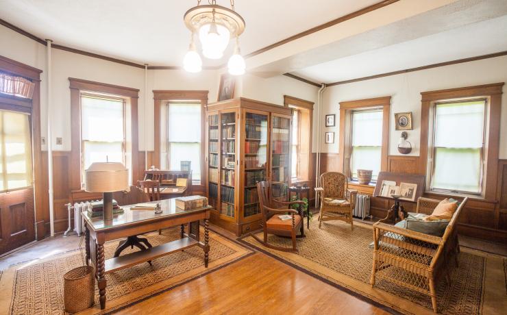 A historical office with a desk and a reading nook