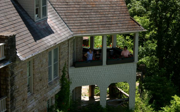 Three people on a balcony looking over the Bothwell Historic Site