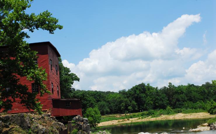 Red mill by a body of water