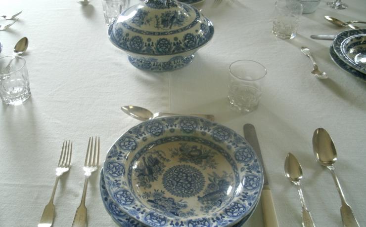 A table set with blue and white china dishes