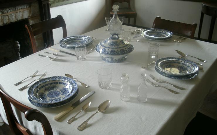 A table set with blue and white china dishes