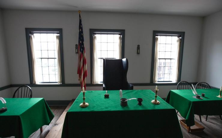 3 tables at the front of a meeting room