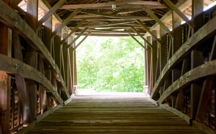 Inside of a wooden covered bridge
