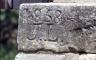 An old brick with the year 1858 and the initials J.L. carved into it
