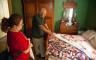 Two people looking at quilts on display