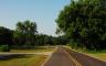 A paved road with trees along the sides