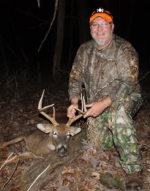 A hunter posing with a deer