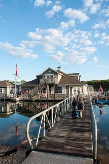 Two people walking on a wooden pier over a lake