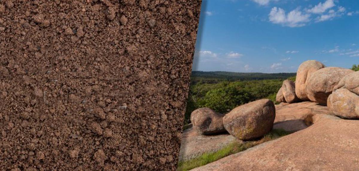 Brown soil next to granite rock formations.