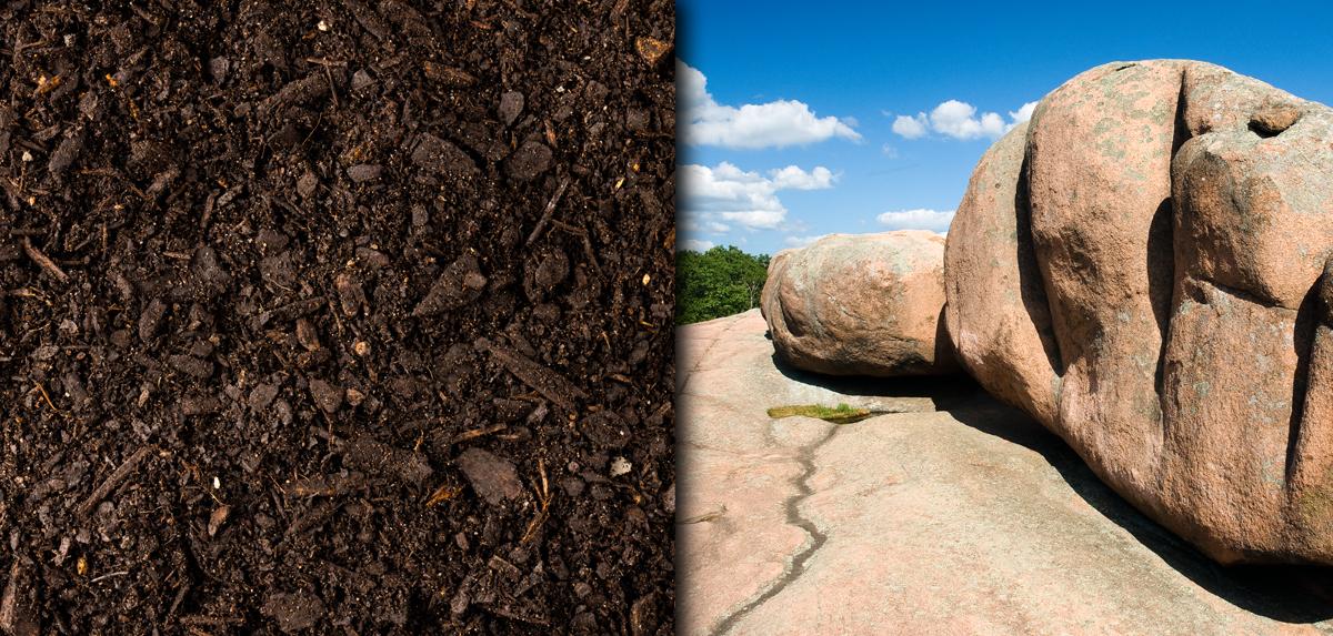 Brown soil next to granite rock formations.
