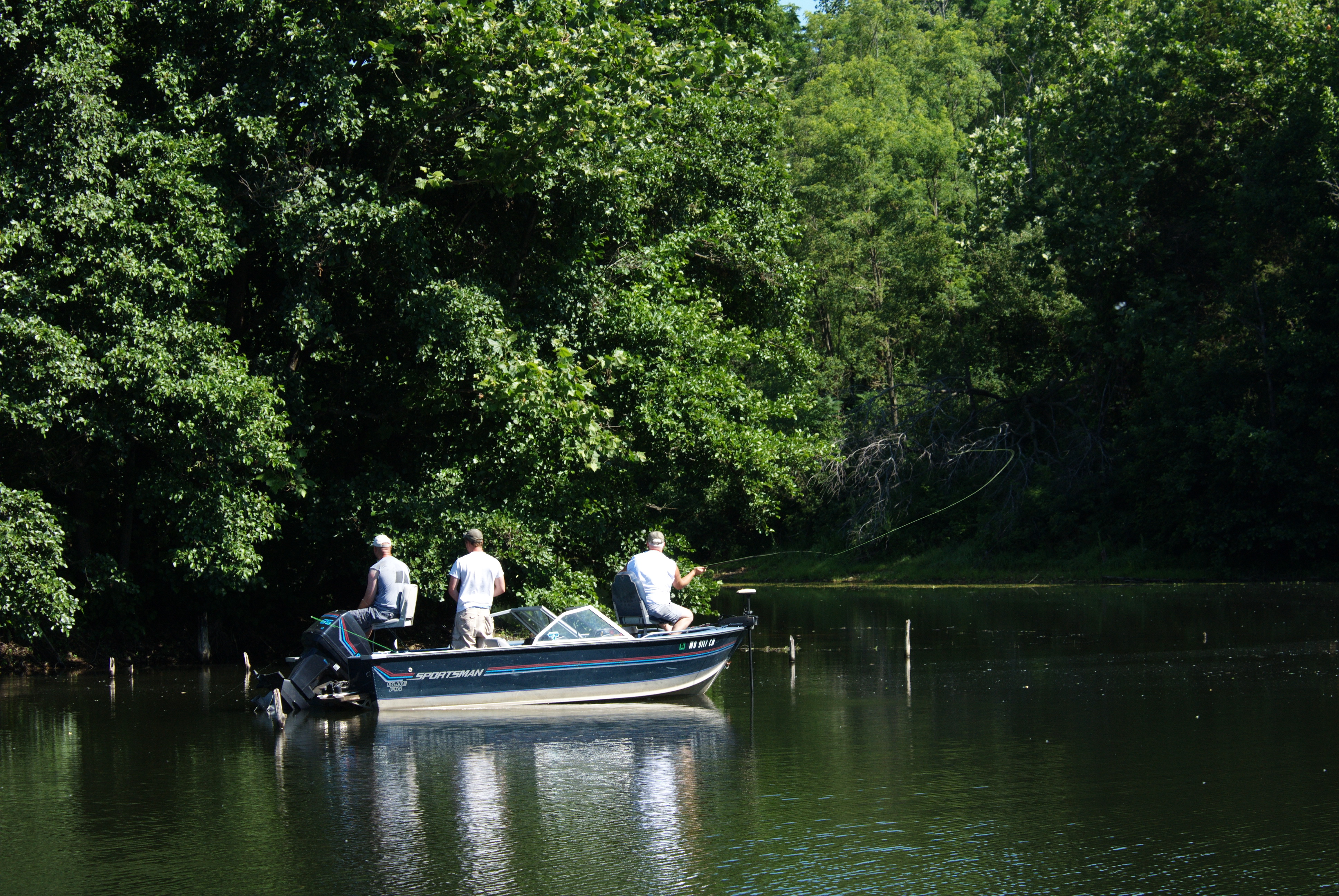 three men fishing in a boat