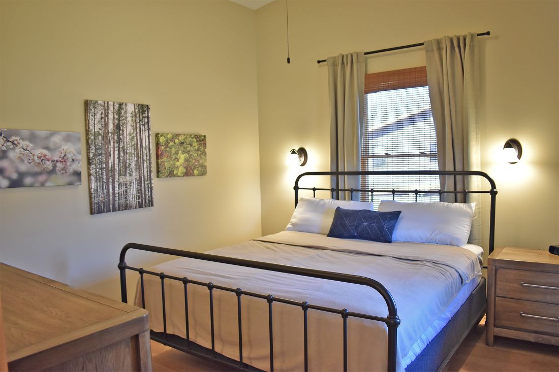 View of bedroom with bed and dresser