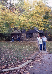a family walks down a path from one of the cabins