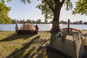 tents set up in the campground next to the lake