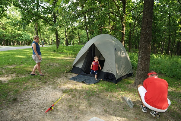 a family setting up their tent