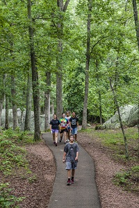 people walking on the paved Braille Trail