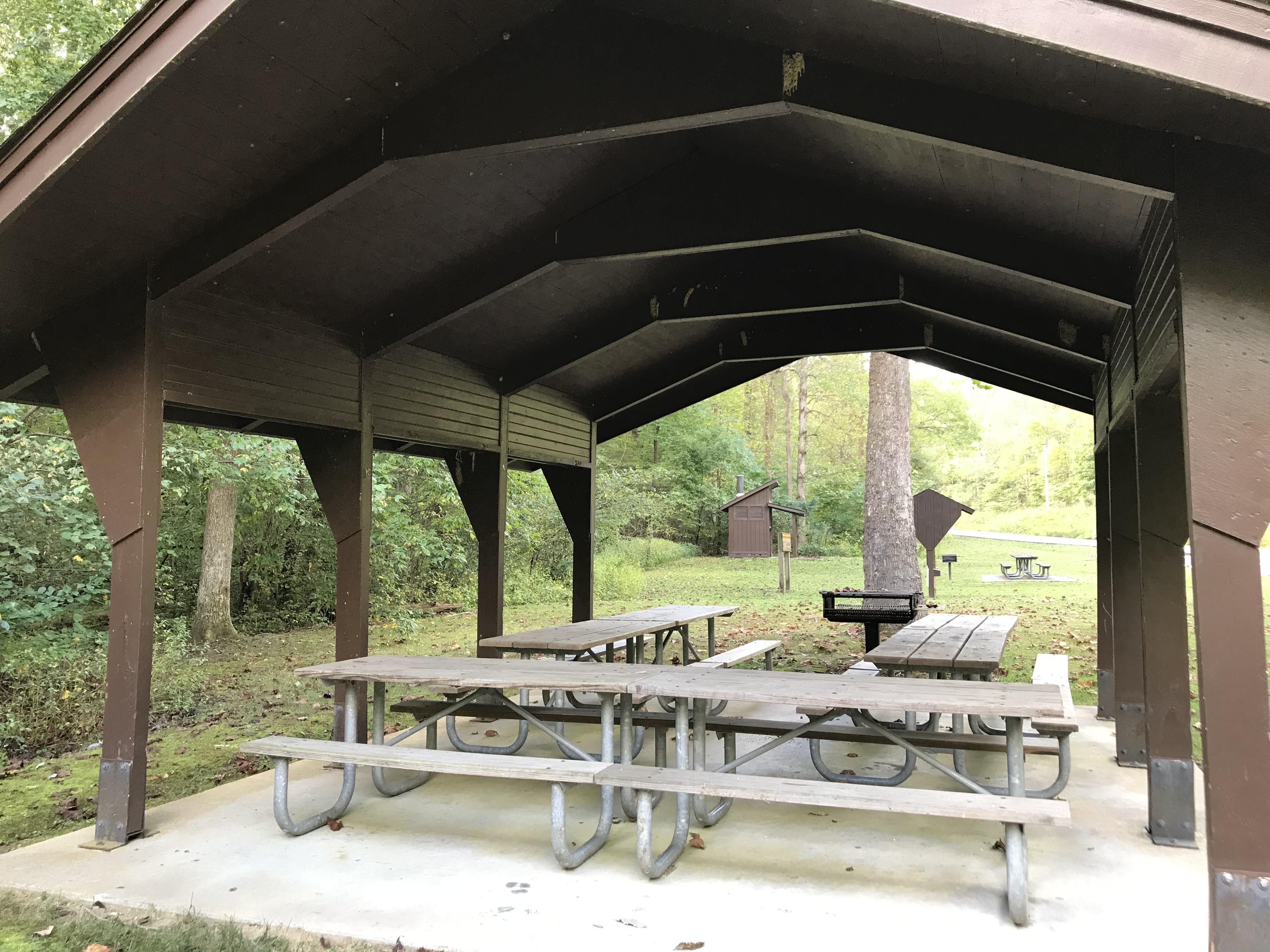 Open picnic shelter with tables and grill