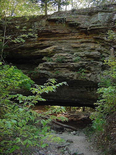 layers of rock that form the rock bridge and the path that goes under it
