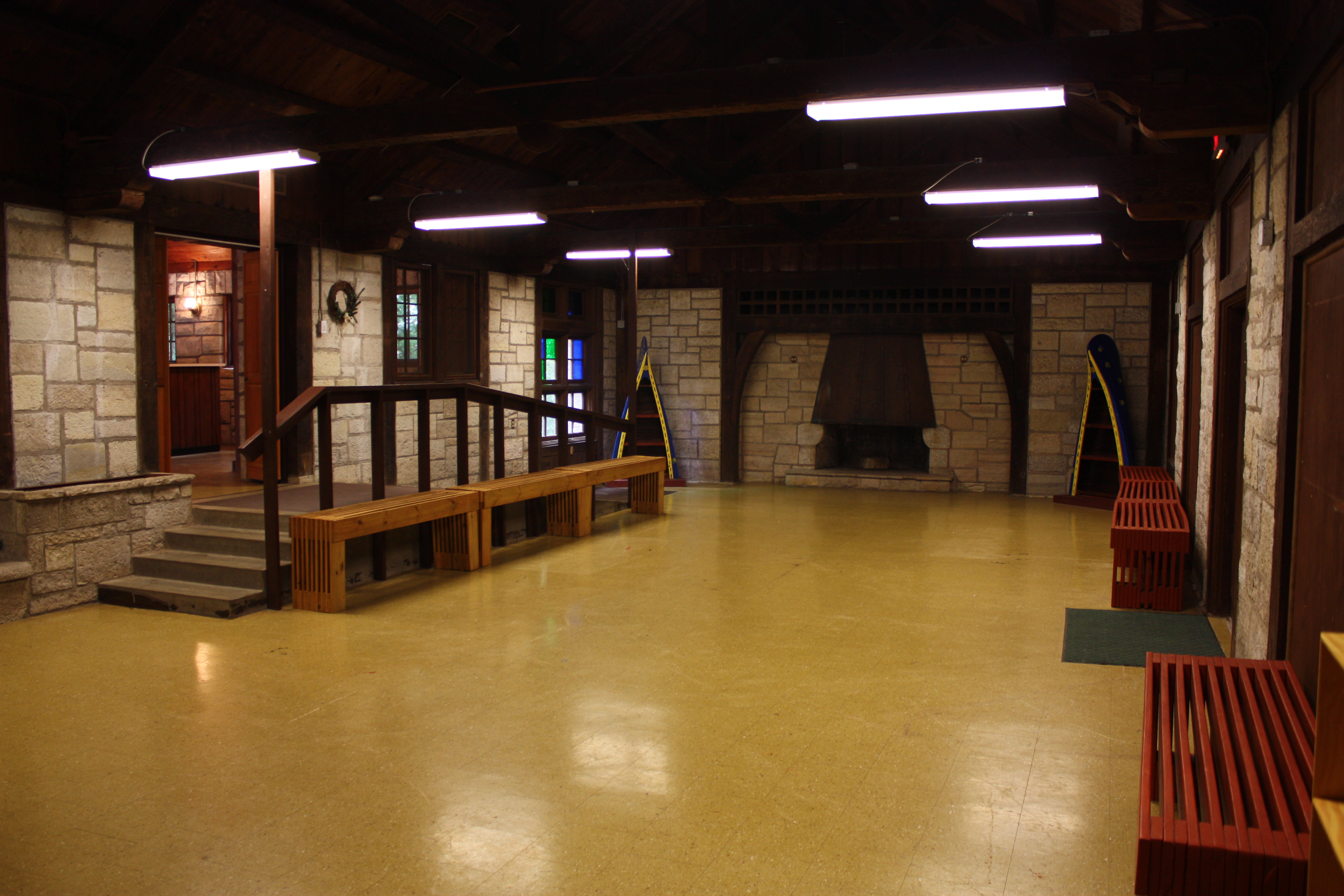 The main room of the enclosed shelter - an open area with a tile floor and benches along the walls