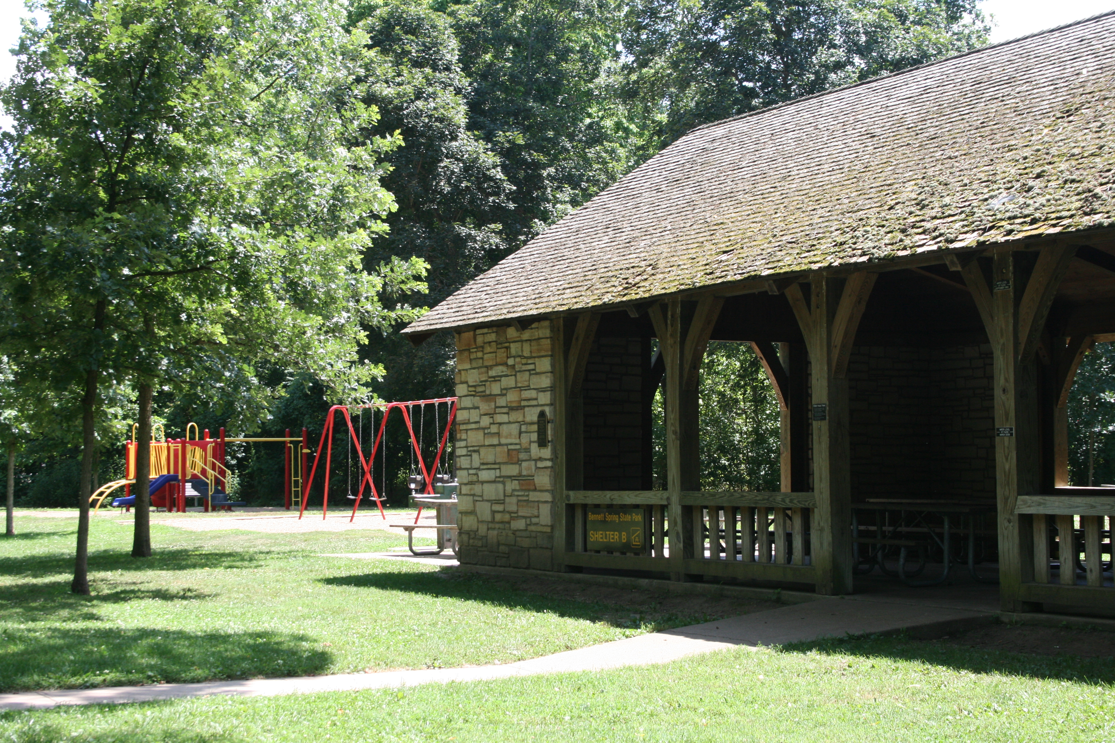 rock picnic shelter with playground in background