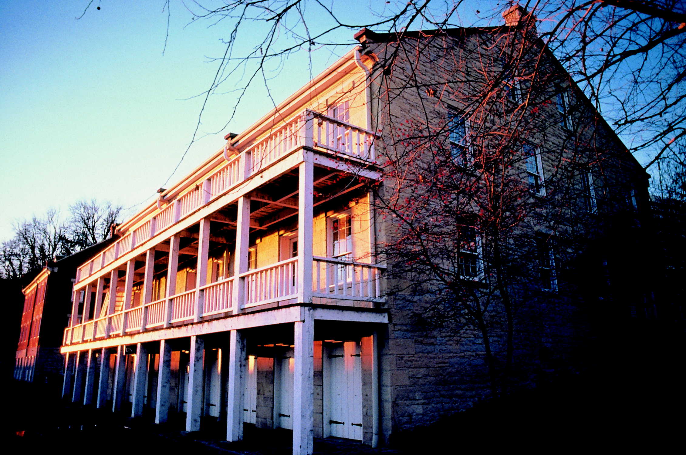 white rock Lohman Building with white railed porches