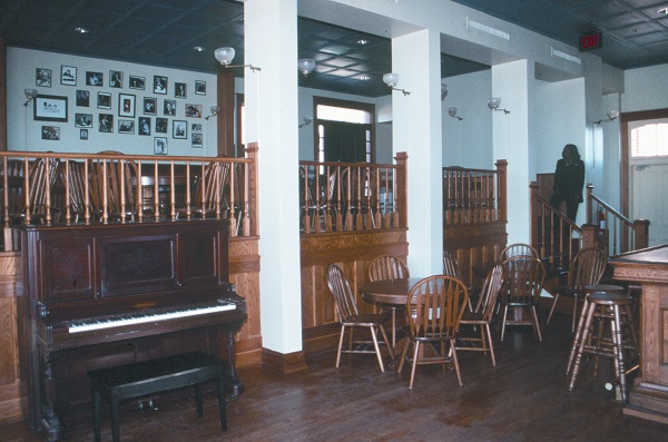 chairs, tables and a piano inside the Rosebud Cafe