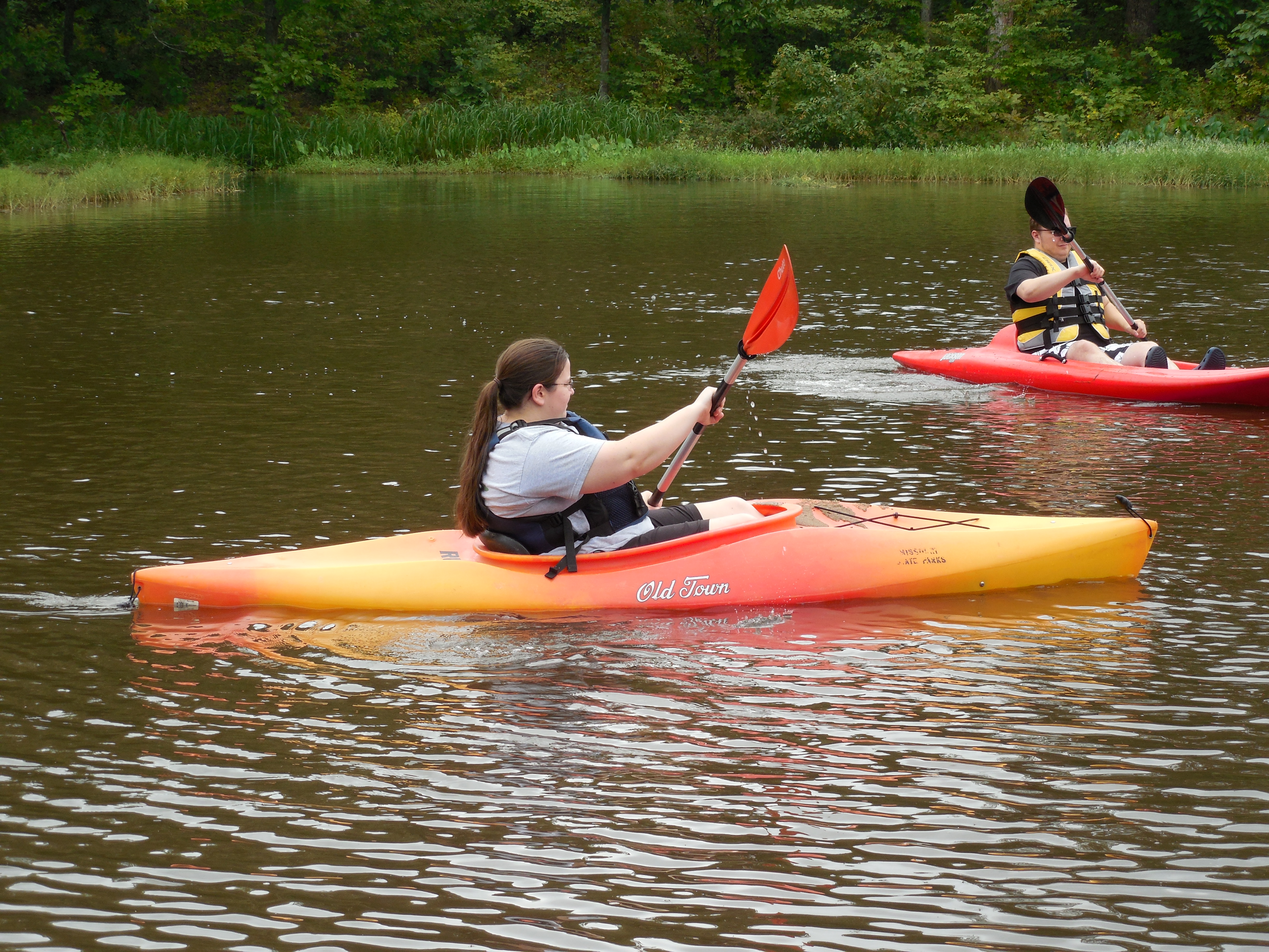 two people kayaking on the lake