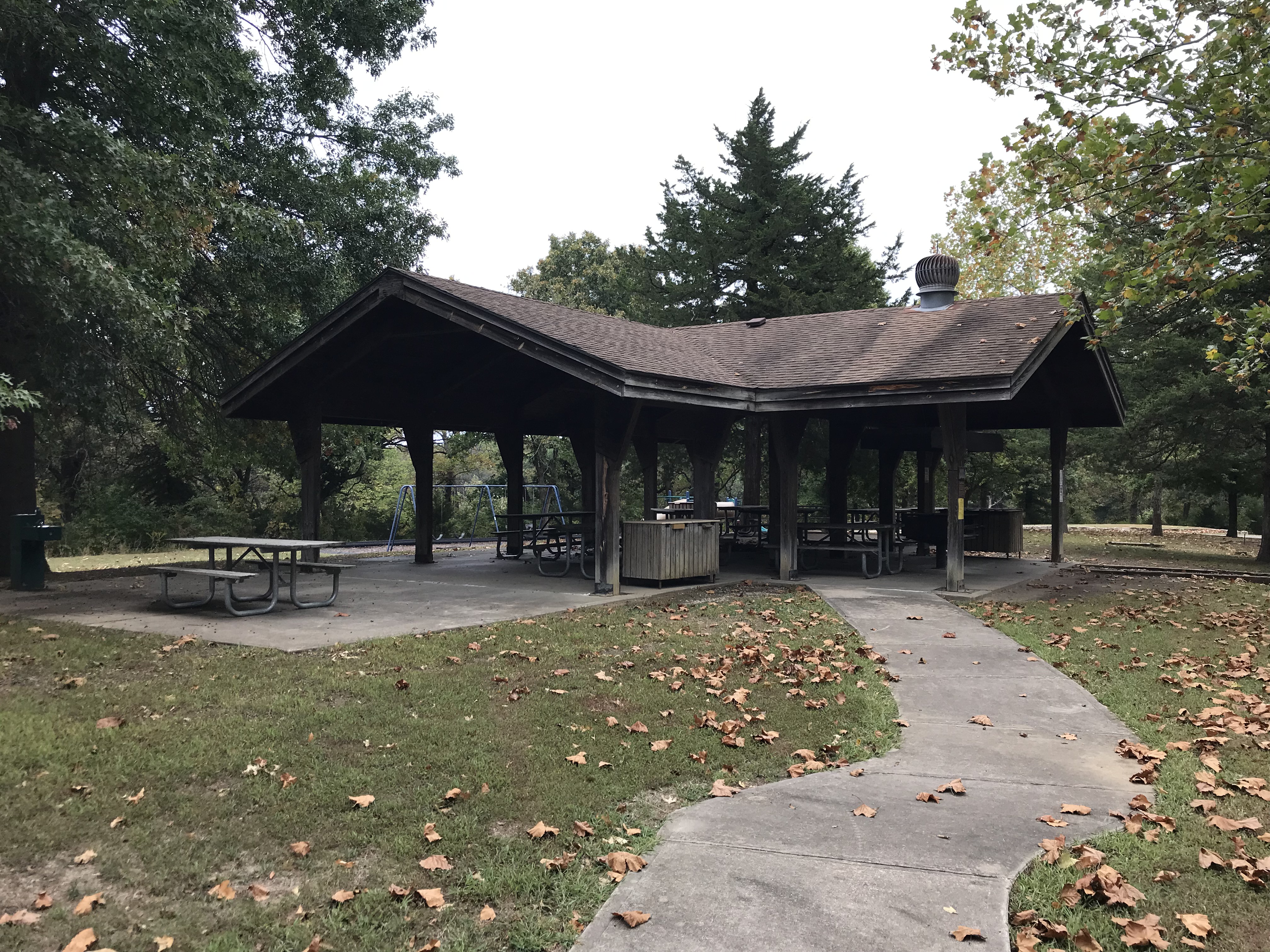Picnic shelter and tables, with sidewalk leading to shelter
