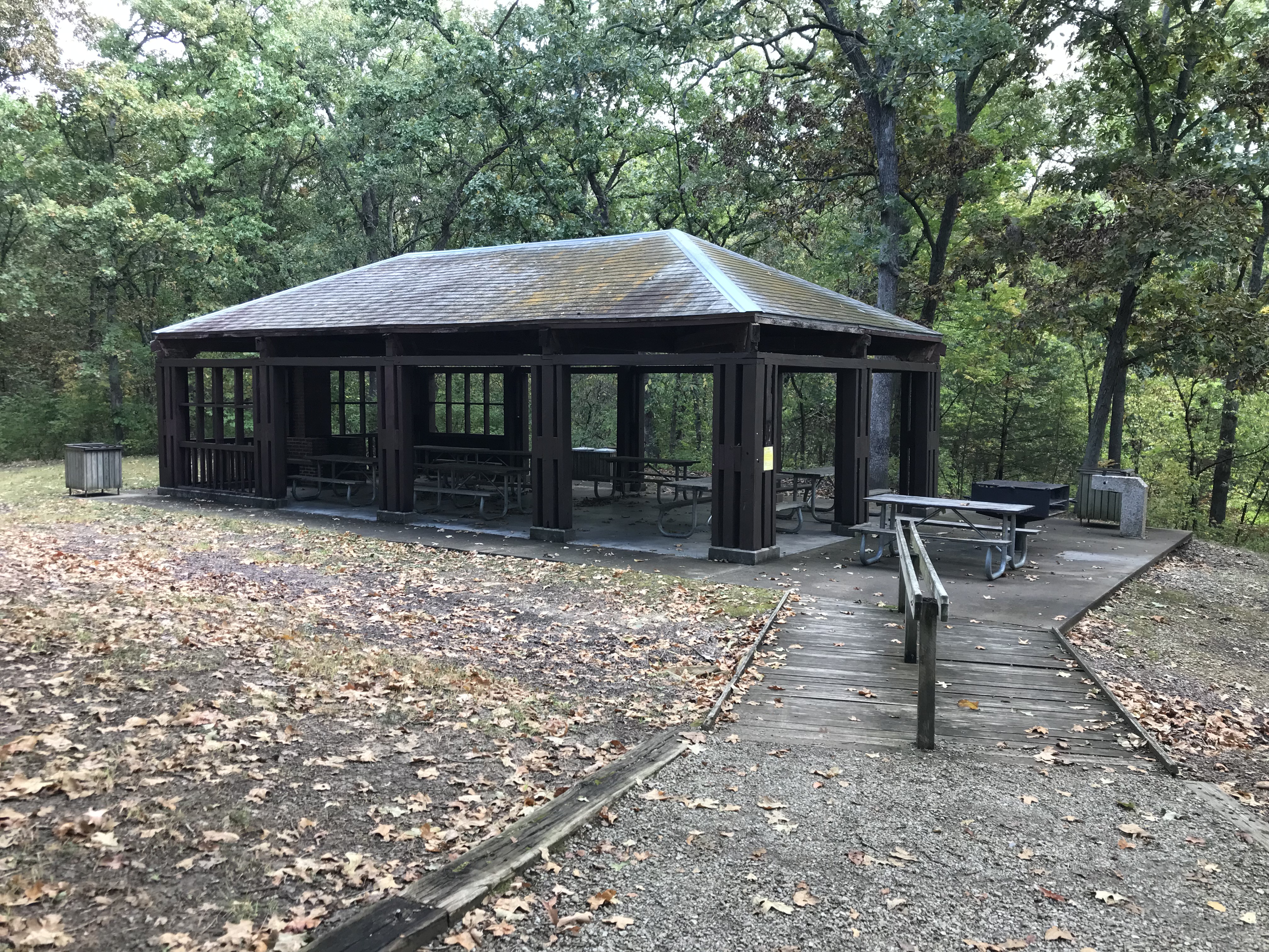 The open, pavilion-style shelter, with picnic tables, a grill and trash bins