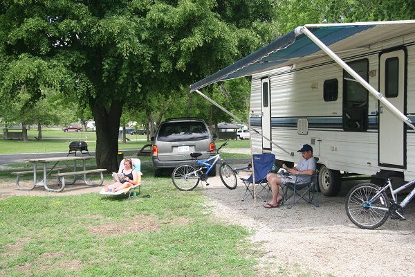 a couple reading in front of their camper