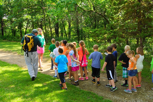 a group of kids on a guided hike