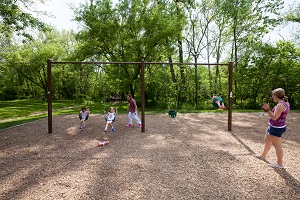 children swinging on swing set