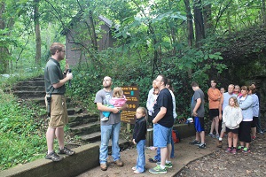 a group listening to an interpreter on a guided hike