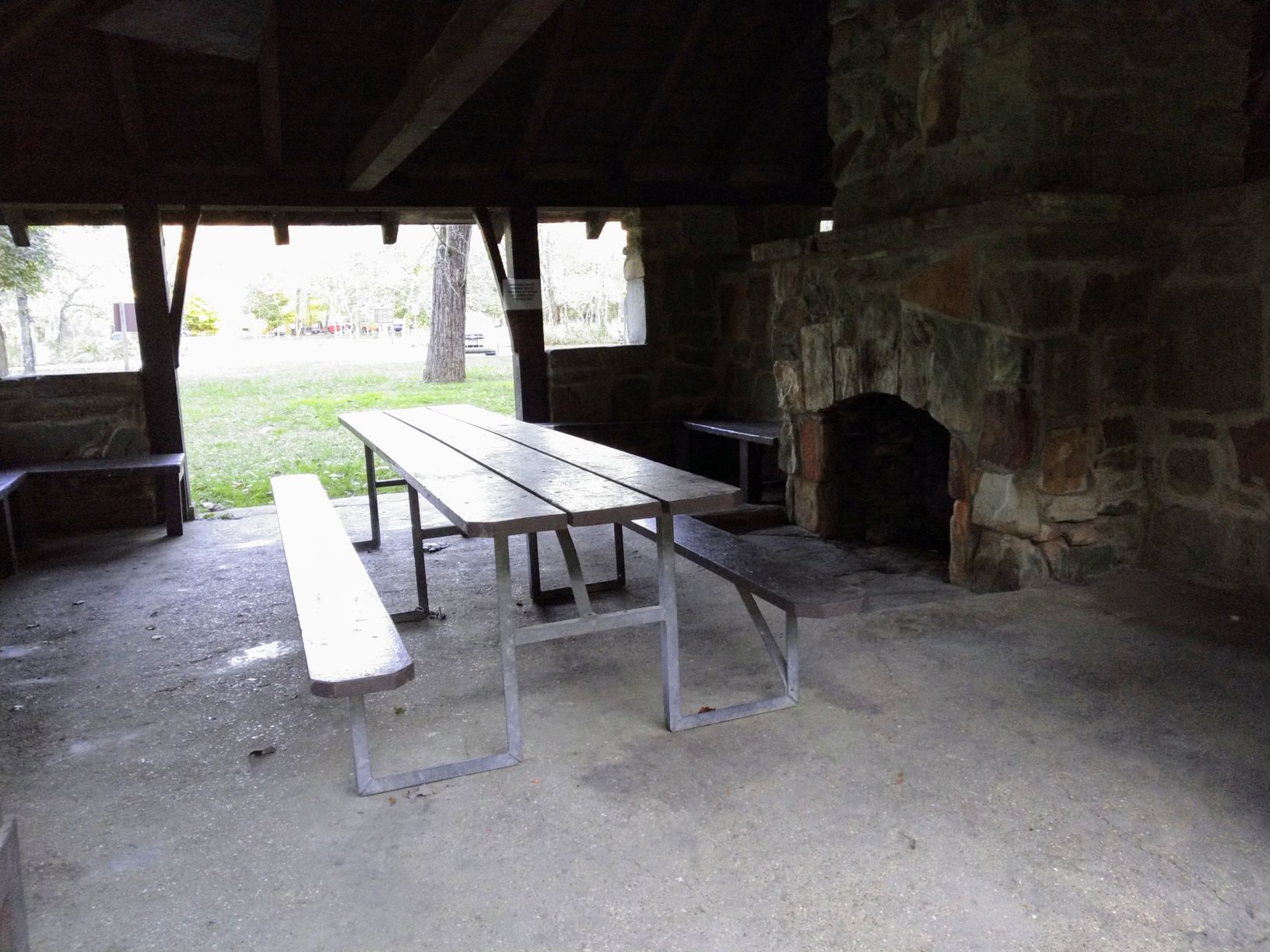Picnic table and stone fireplace inside the CCC shelter
