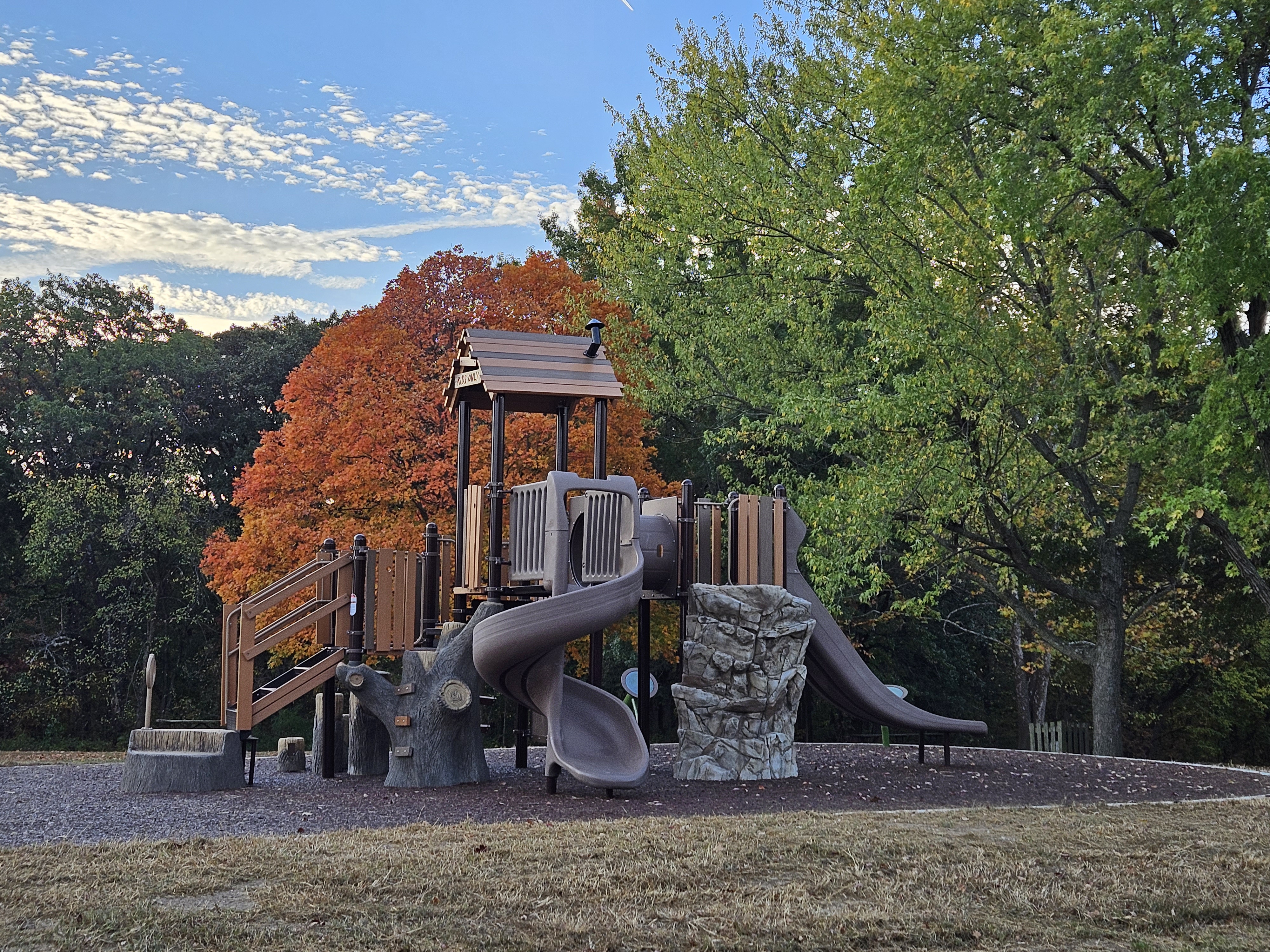 plagyground equipment with slides and a swing set