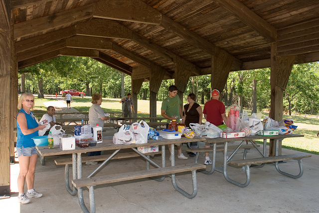 People gathered under one of the picnic shelters