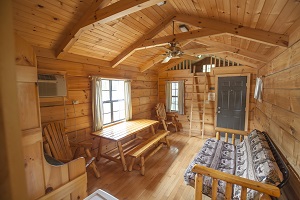 futon and table with bench inside a camper cabin