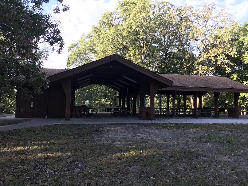Open picnic shelter, shaded by trees