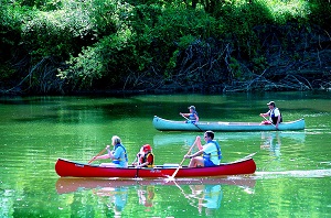 two canoes of people on the river