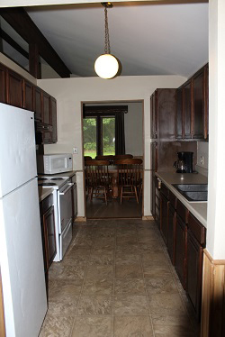 Kitchen with stove, refrigerator and sinks inside a cabin