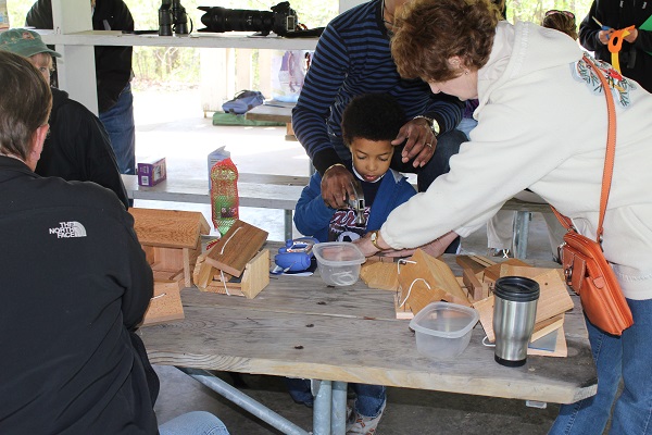 kids and adults building bird feeders